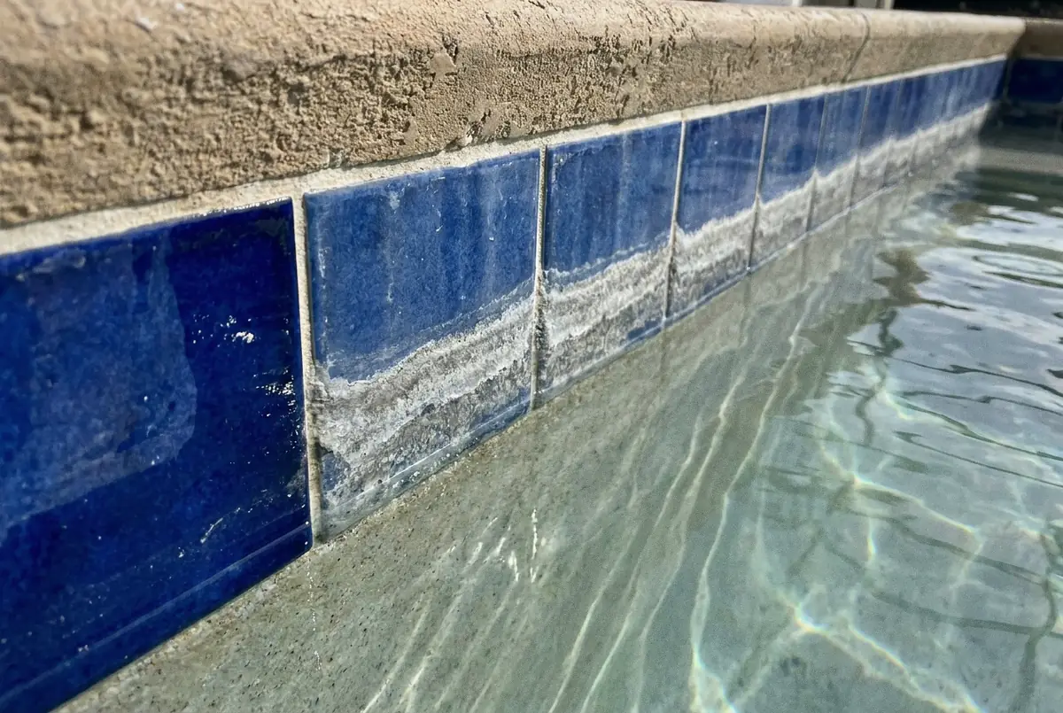 Blue waterline tile with a band of white calcium scale just above the water surface, Deltona, FL