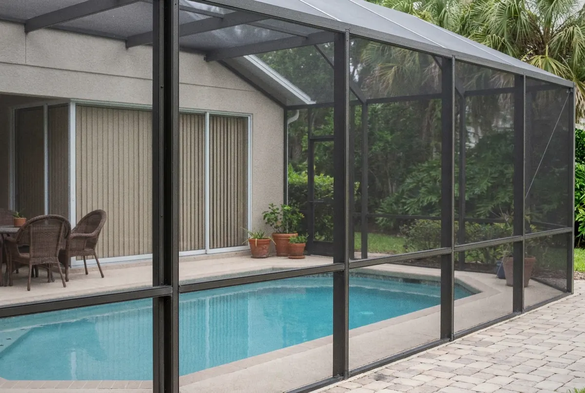 Quiet screened pool behind a home with the blinds closed and patio chairs pushed in, Deltona, FL